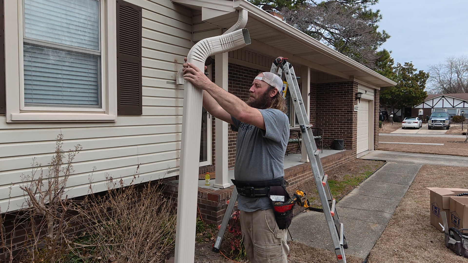 John Fischer installing seamless gutters